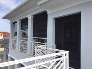 Patio enclosed with motorized screens overlooking Dallas, TX backyard and pool